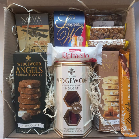 Box of assorted snacks including Wedgwood Anglets, Raffaello, and other confectionery items.
